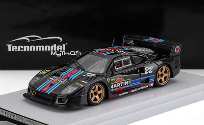 Modellino di auto da corsa Black Martini con strisce blu e rosse, ruote dorate, in esposizione, disponibile tramite Vroomi.