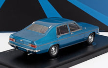 Blue 1972 classic four-door model car displayed on a black stand, now available on Vroomi