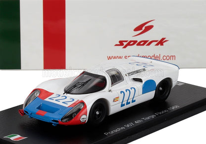 Modellino in scala 1/43 dell'auto da corsa Porsche 907 nei colori bianco, rosso e blu con il numero 222, esposto su un supporto.