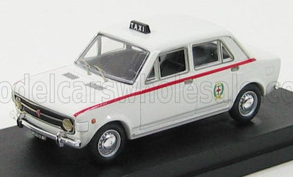 Modellino di taxi vintage bianco con striscia rossa e insegna taxi sul tetto, disponibile su Vroomi.