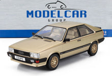 Modellino di auto Audi coupé dorata in scala 1/18 con interni dettagliati, esposto con il marchio Model Car Group, disponibile su Vroomi.