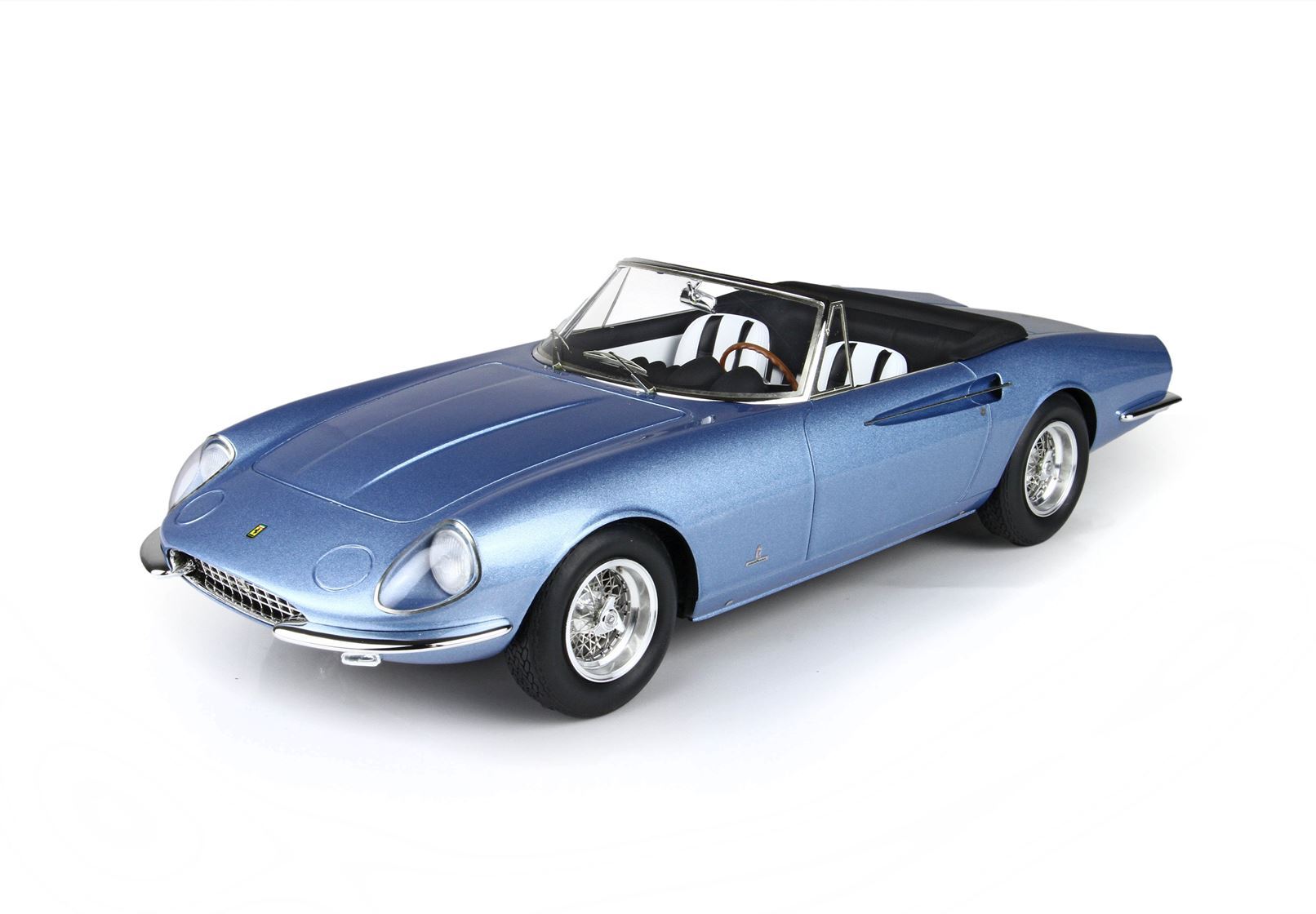 Blue vintage convertible sports car model with wire wheels and black interior, offered on Vroomi