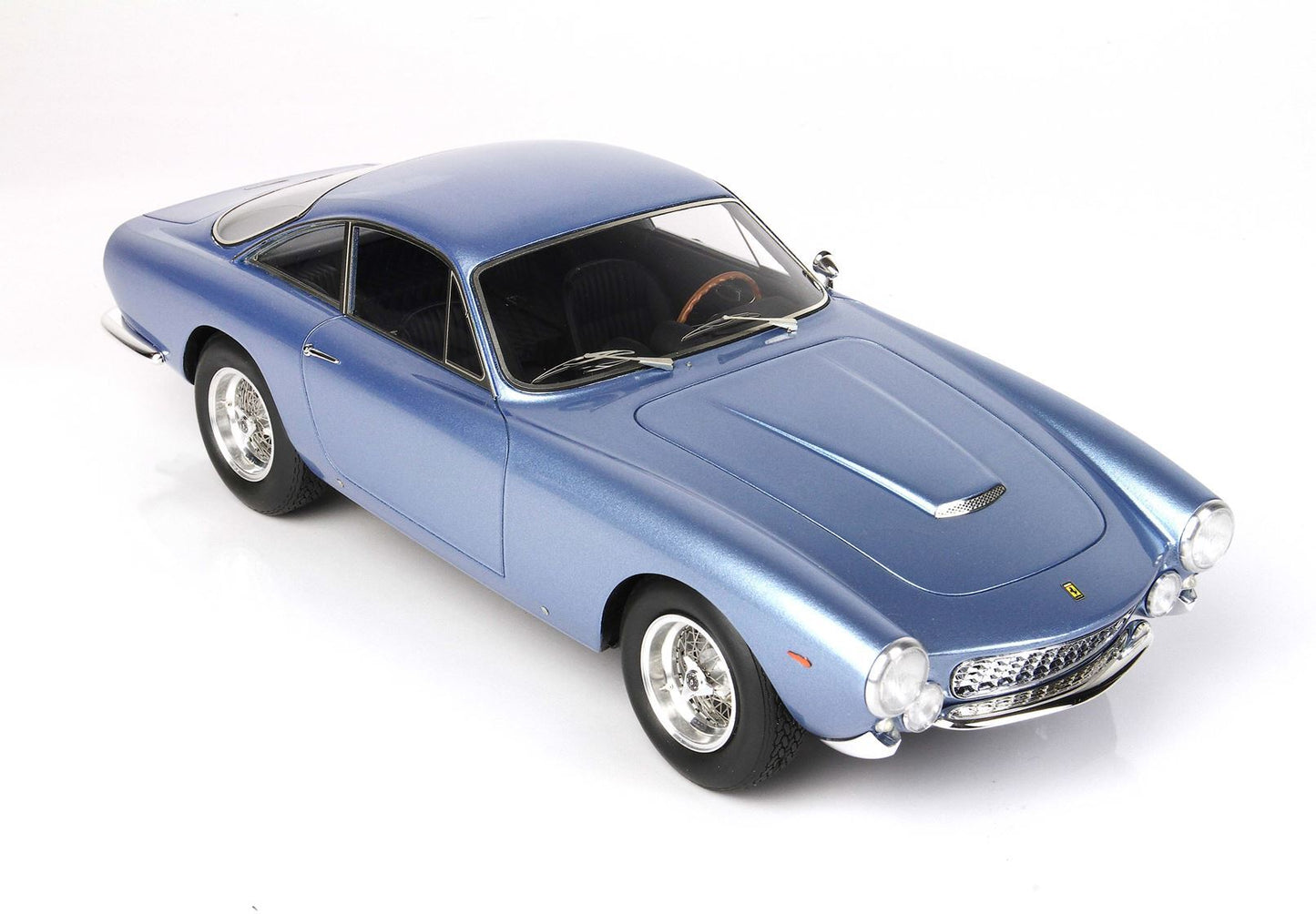 Blue classic Ferrari model car with wire wheels and wooden steering wheel, available on Vroomi
