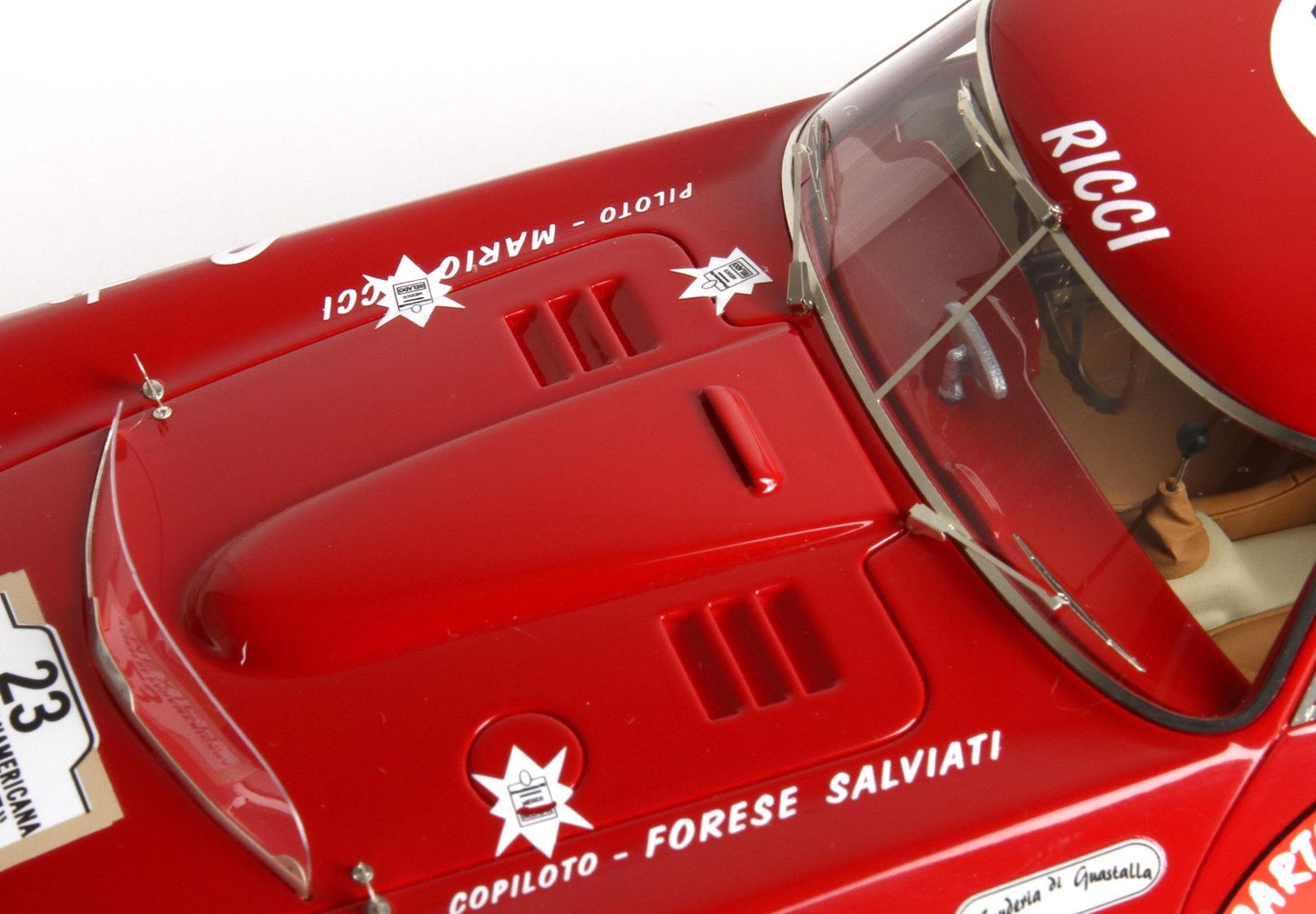Close-up of red vintage race car hood with windshield and driver names, available on Vroomi platform