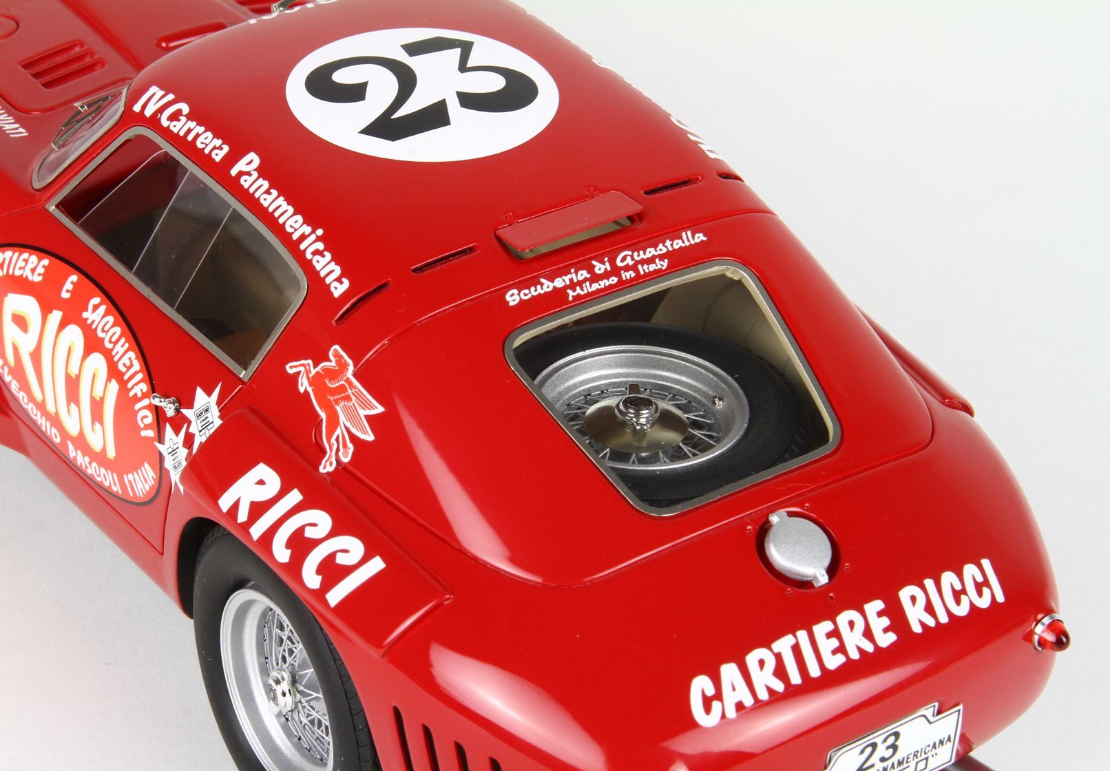 Red vintage race car model with number 23, Ricci sponsorship, and visible spare tire, available on Vroomi