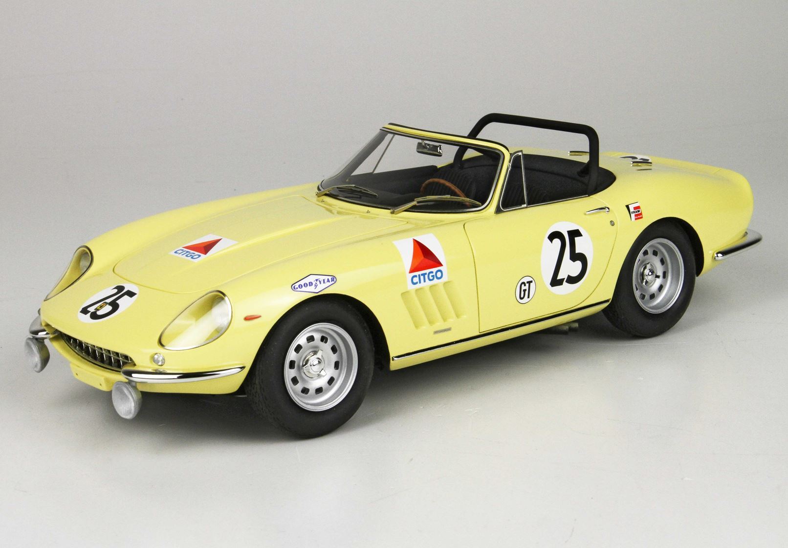 Yellow vintage race car with number 25, Citgo and Goodyear decals, open-top, available on Vroomi