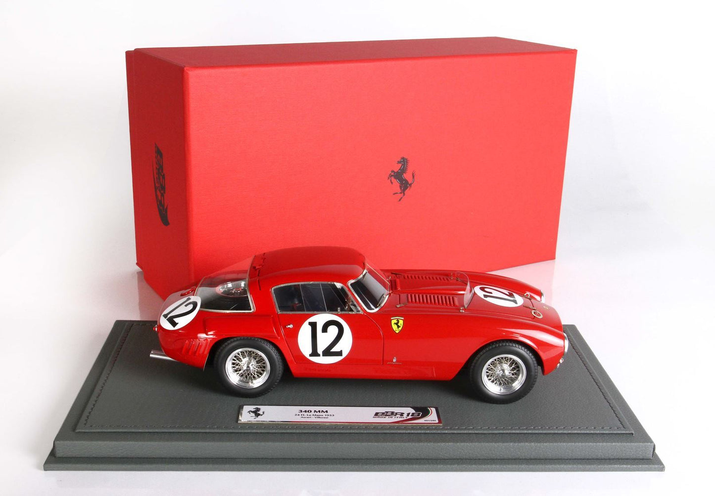 Red Ferrari 340 MM model car with number 12 on gray display base, classic red box, available through Vroomi