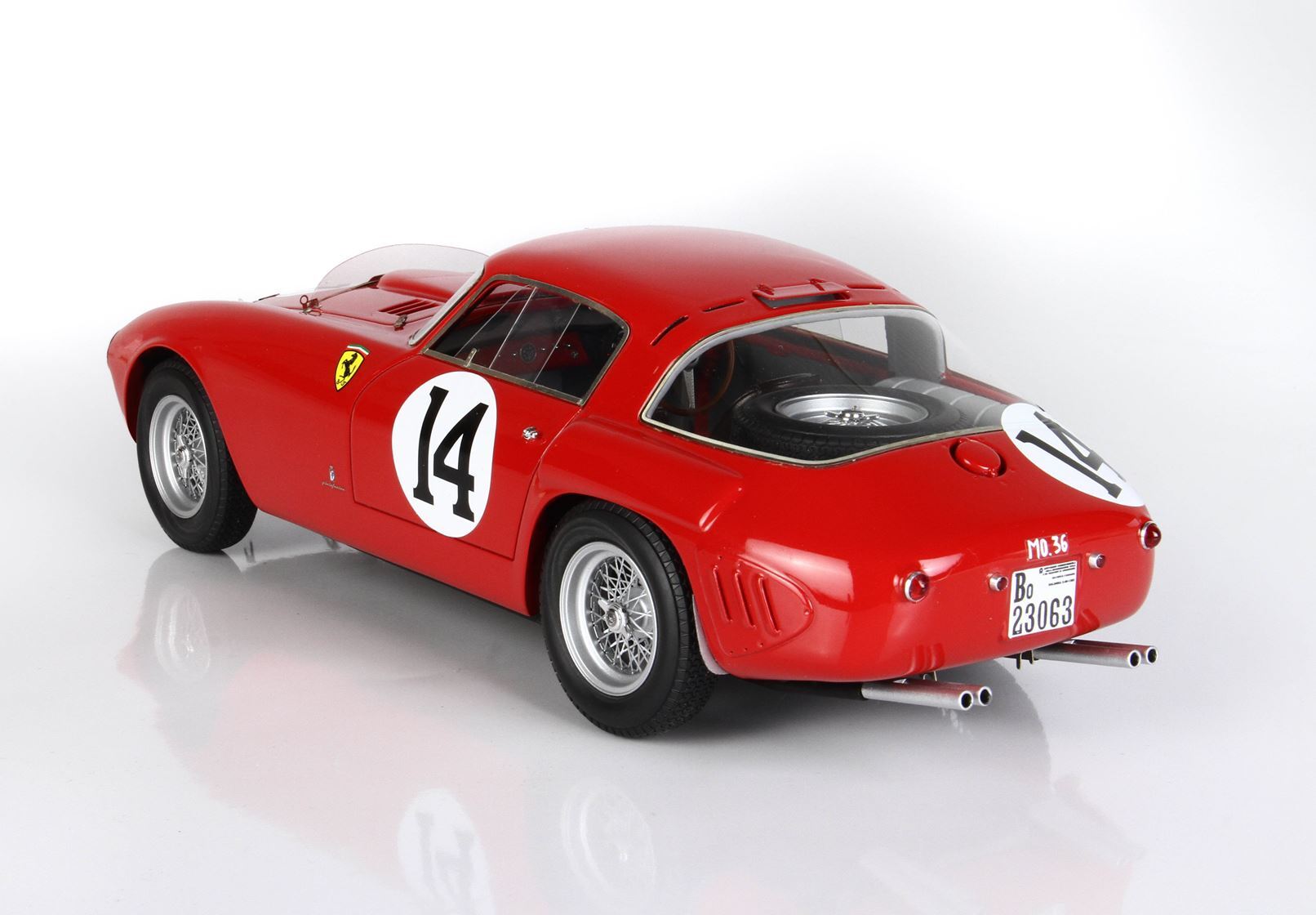 Red vintage Ferrari race car model with number 14, wire wheels, rear spare tire, and dual exhaust, available on Vroomi