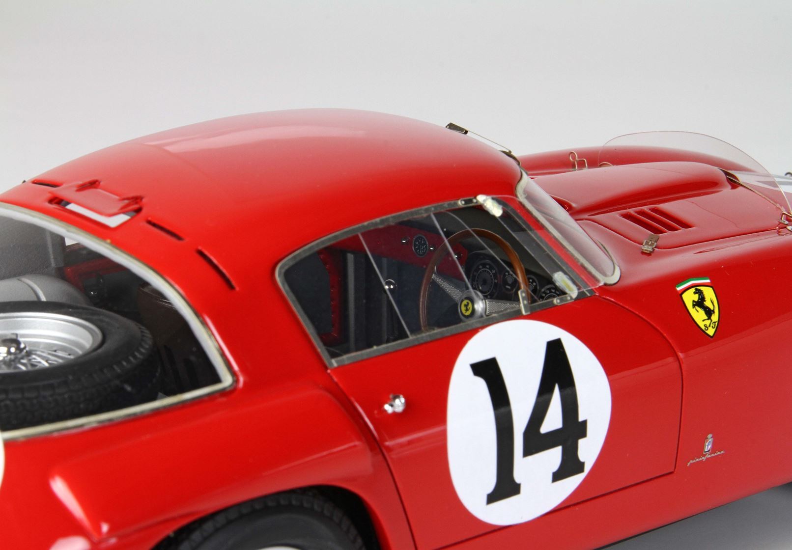 Close-up of red vintage Ferrari race car model with number 14 and detailed interior, offered on Vroomi