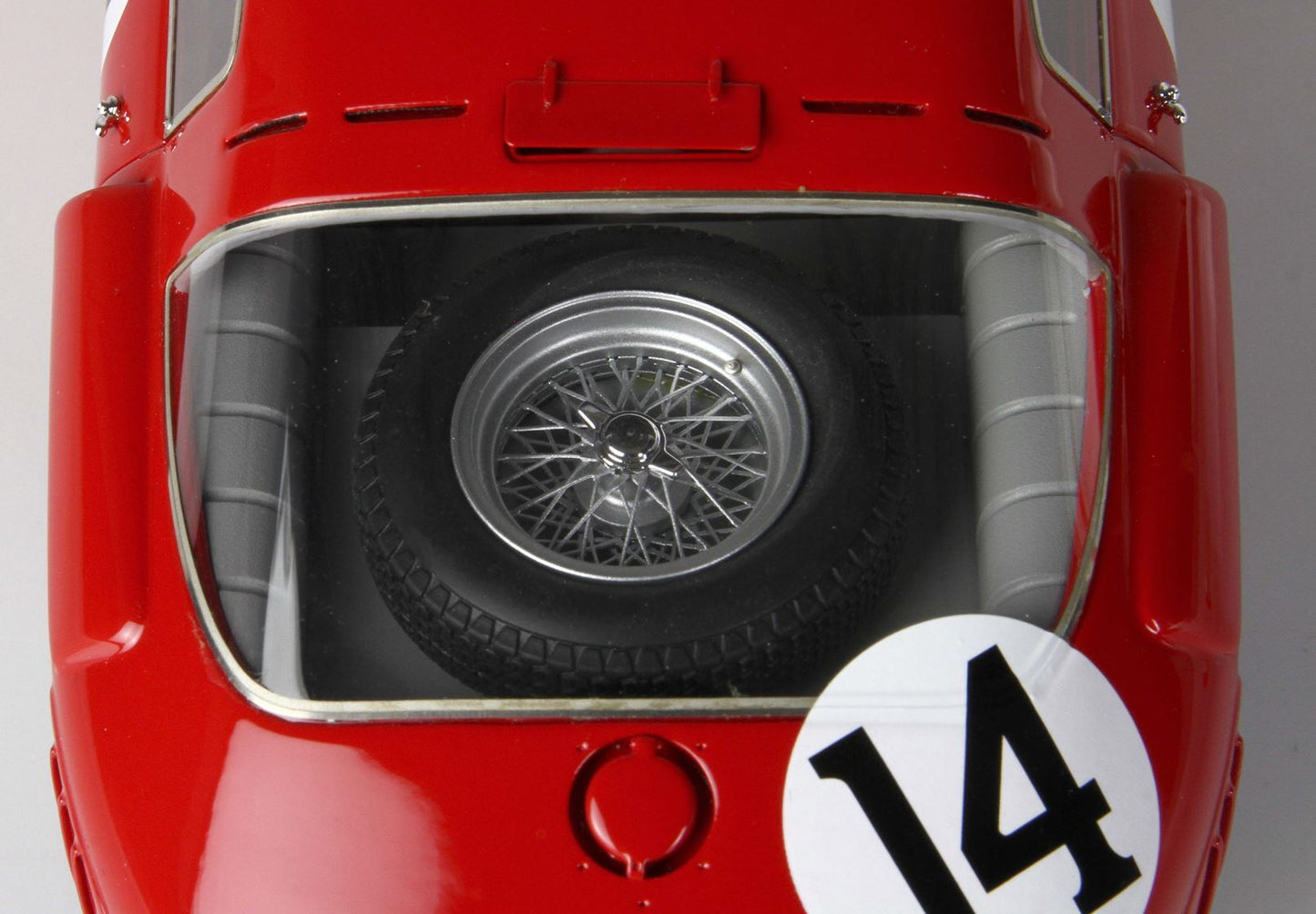 Top view of red classic race car with spare tire visible under rear window, number 14, available on Vroomi