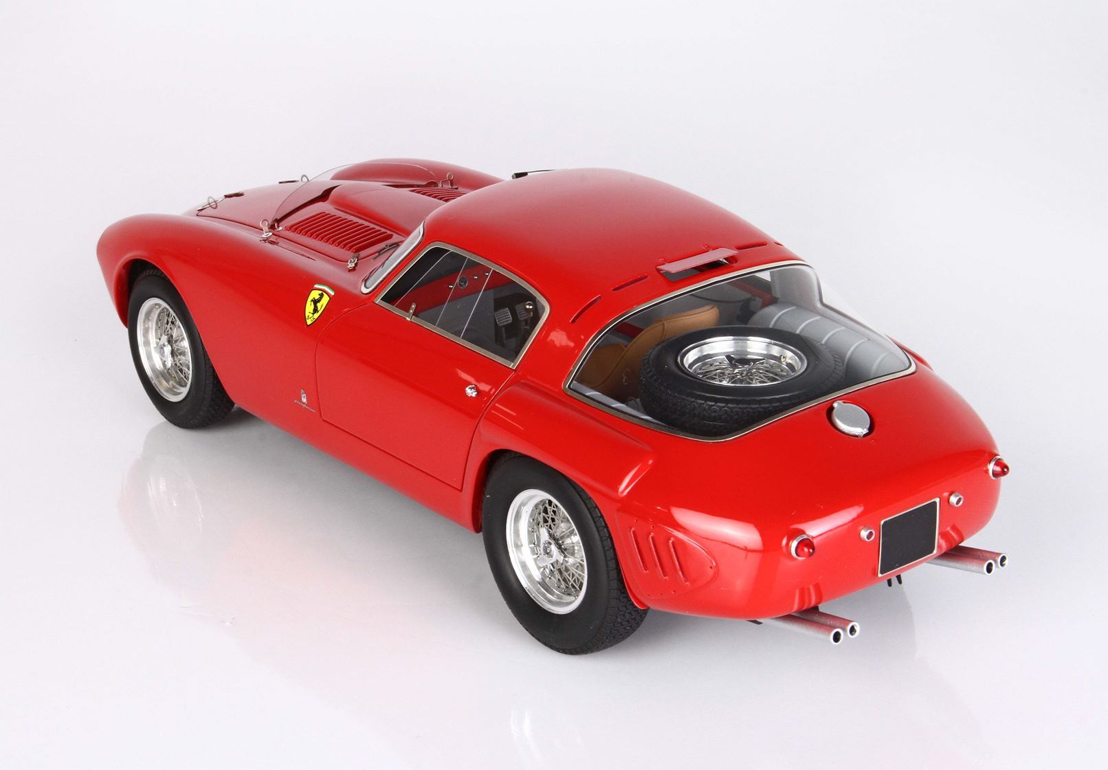Red classic Ferrari sports car model with spare tire on rear deck, featured on Vroomi