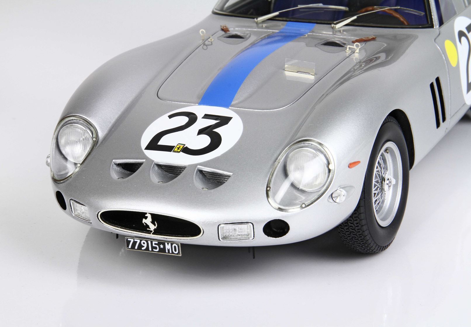 Close-up of silver Ferrari race car front with blue stripe and number 23, offered on Vroomi