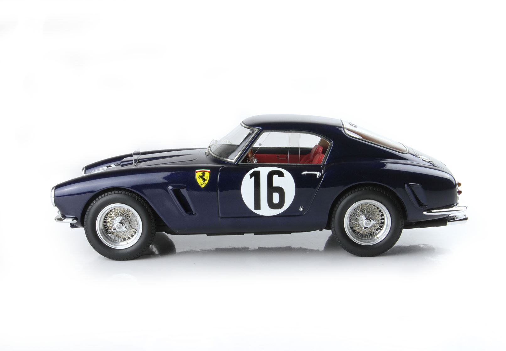 Dark blue vintage Ferrari race car with number 16, wire wheels, and red interior, available via Vroomi