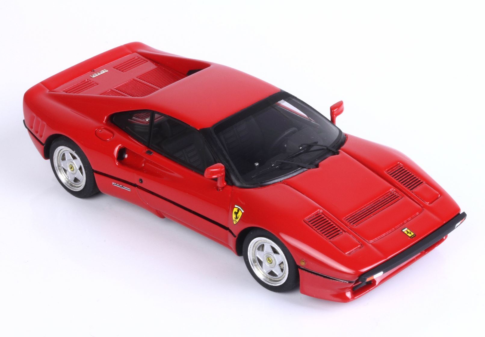 Red Ferrari sports car model with detailed vents and black interior, available through Vroomi