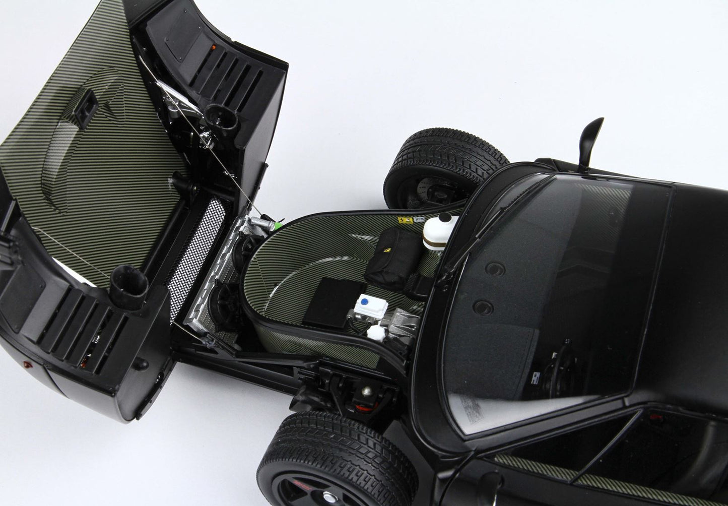 Black sports car front trunk open showing detailed interior with tire and components, available on Vroomi