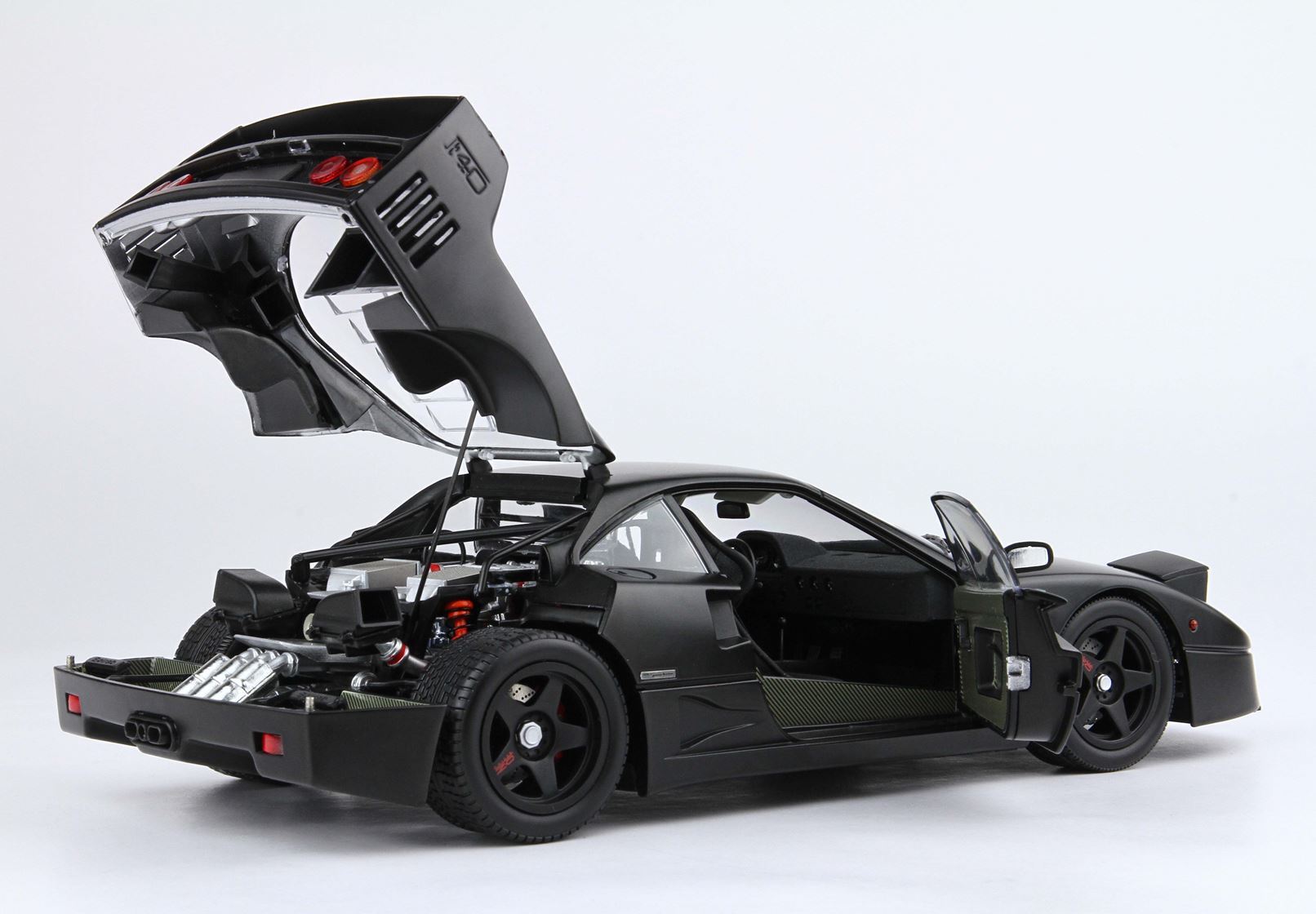 Black sports model car with open rear hood and door showing detailed engine and interior, available on Vroomi