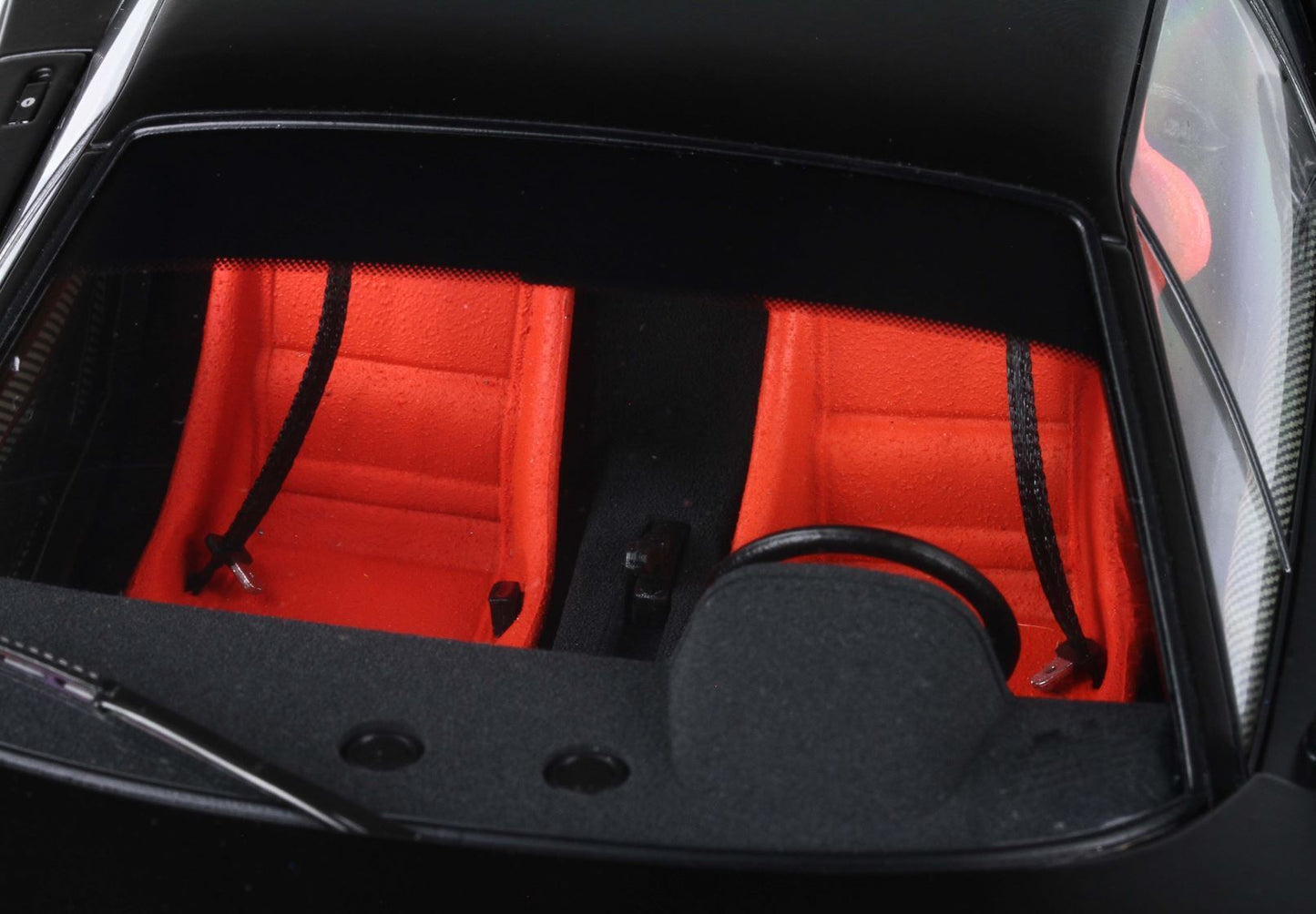 Car interior with vivid red sport seats and black steering wheel, offered on Vroomi platform