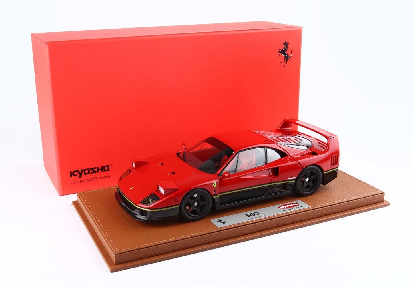 Red and black Ferrari F40 model car on a brown base with a red Kyosho box, also available on Vroomi