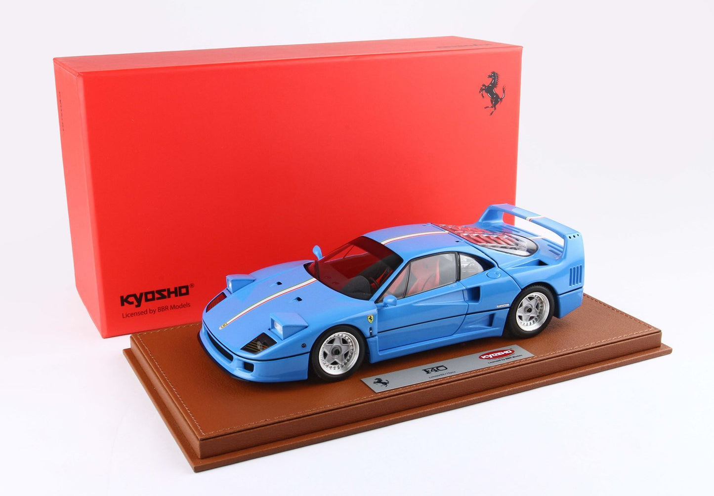 Blue Ferrari F40 model car on brown display base with red Kyosho box, available on Vroomi