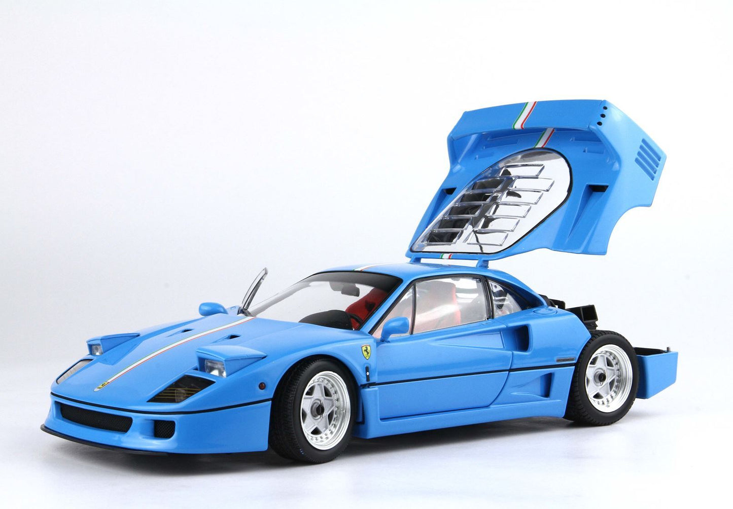 Blue Ferrari F40 model car with open rear engine cover and red interior, available for purchase on Vroomi