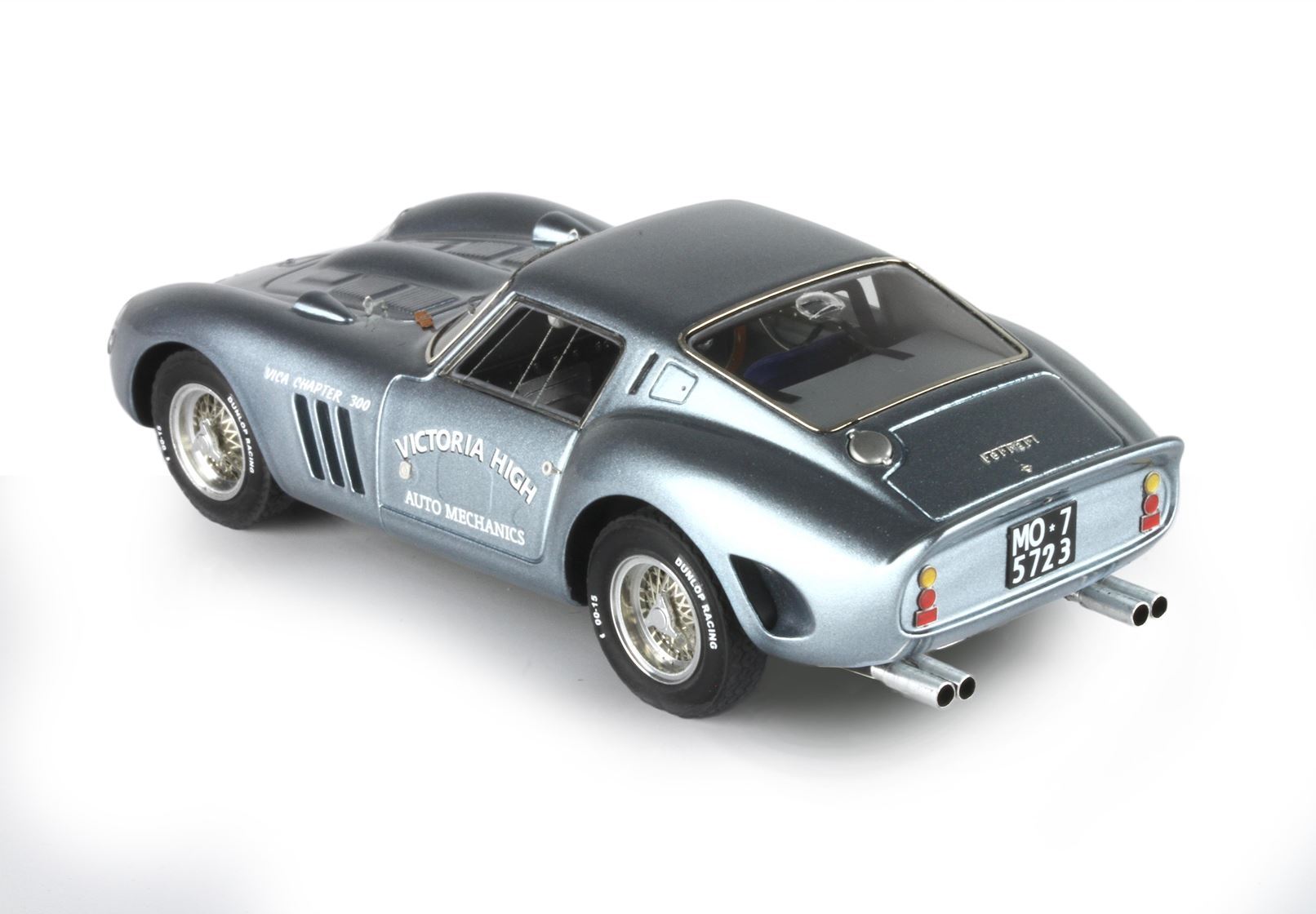Metallic gray vintage Ferrari model car with 'Victoria High Auto Mechanics' decal, available on Vroomi
